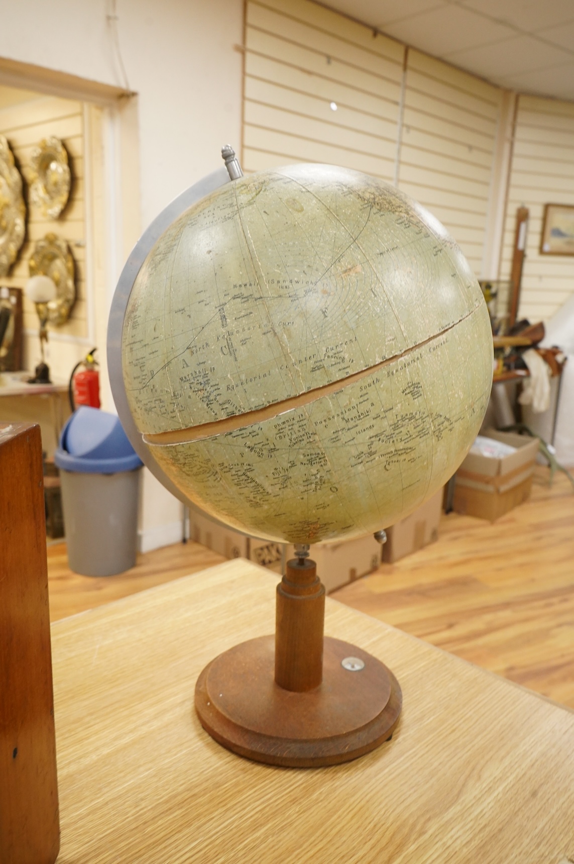 A mid 20th century 12 inch terrestrial globe on an oak base with integrated compass, the globe printed with; ‘Printed in Germany’, overall height 55cm